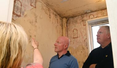 A tenant pointing out the mould and water damage from leaks in the bathroom in a flat at Noonan's Rd, to councillor Mick Finn (right) and community activist William O'Brien in 2023. File picture: Denis Minihane