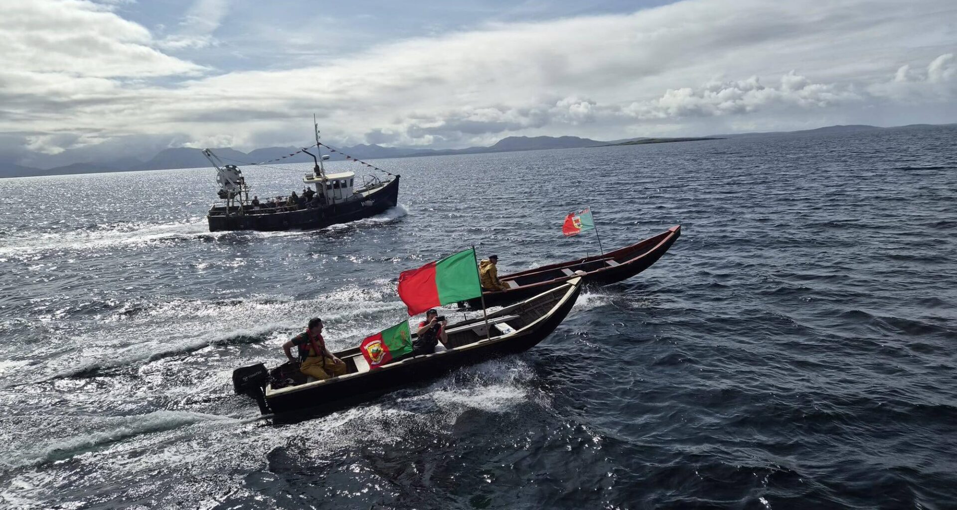 Here they come: The ferry carrying Sam Maguire is escorted across from the mainland to Inishturk Island off Mayo.