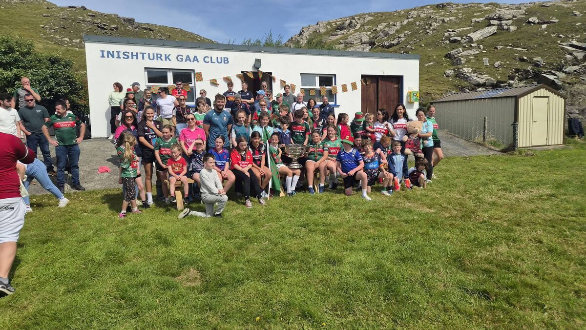 WELCOMING COMMITTEE: The natives and future stars of Inishturk GAA welcome Aidan O'Shea, Jack Carney and Sam Maguire to the island on Thursday. 
