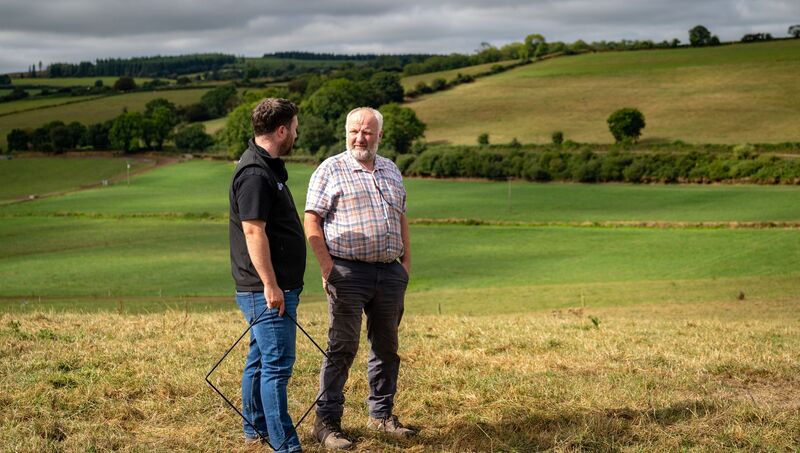 (L-R) Tim Casey and Brian Duncan survey scorched fields on Brian’s farm in East Cork as the ongoing drought leaves grass in poor condition. Picture: Chani Anderson
