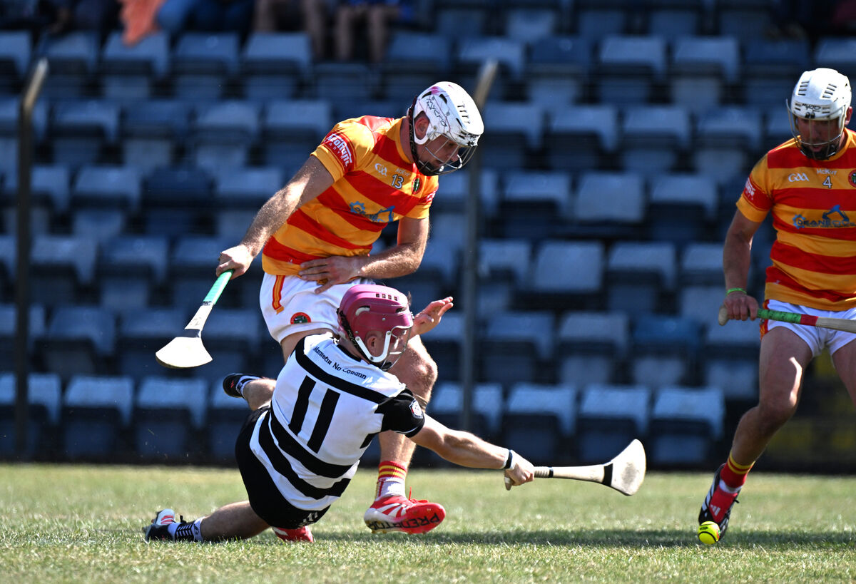  Alex Quirke tries to keep a Midleton attack alive as Gearóid O'Donovan of Newcestown defends. Picture: Larry Cummins