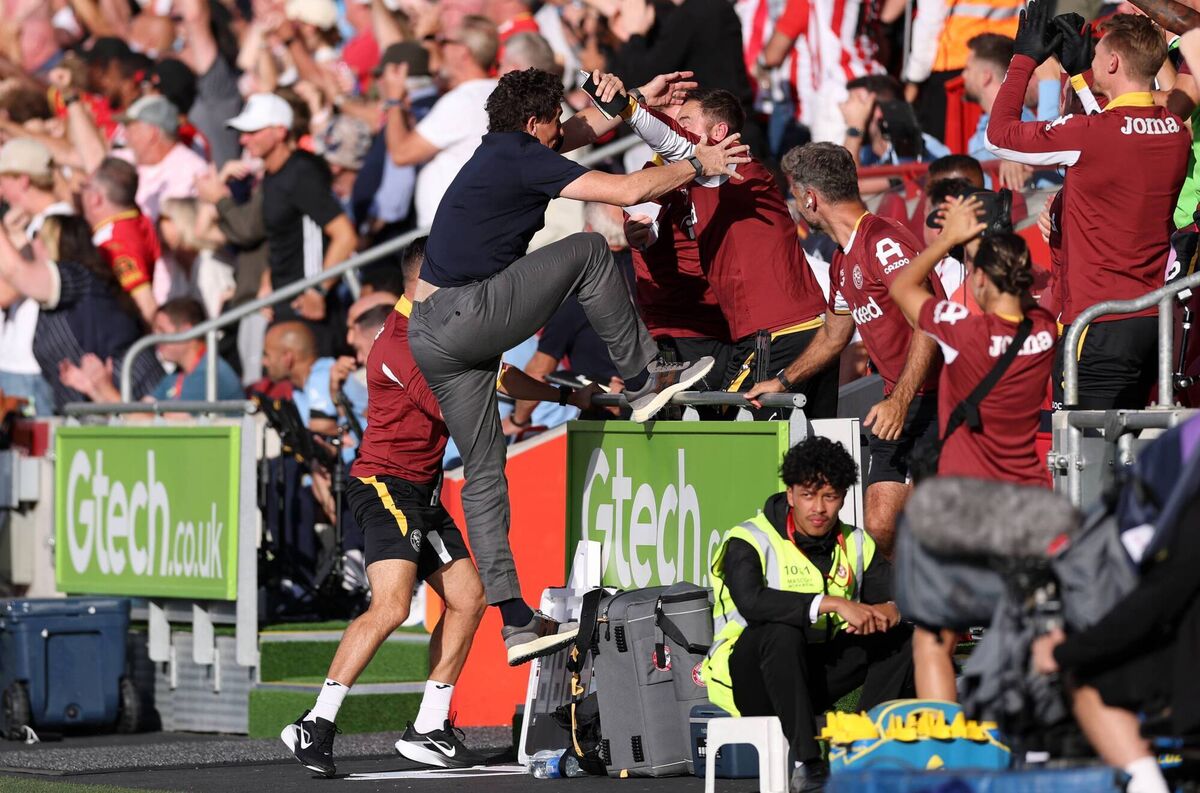 Brentford manager Keith Andrews celebrates with his coaching staff after the team's second goal against Spurs. Pic: Ryan Pierse/Getty Images