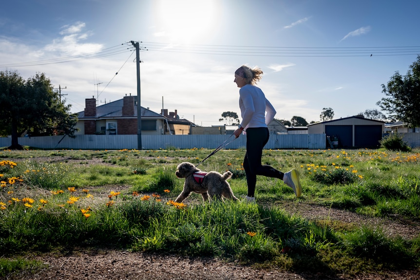 A person running with a dog.