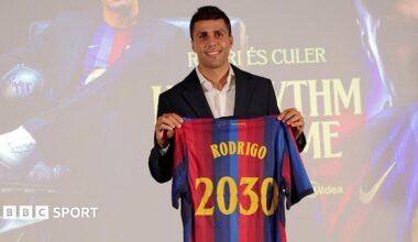 Rodri holds up a Barcelona shirt
