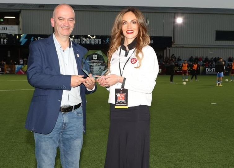 Chief Commercial Officer Nita Whelan makes a presentation to Dundalk Credit Union Chairman Jim Wallace for sponsoring our League of Ireland Centenary Match.