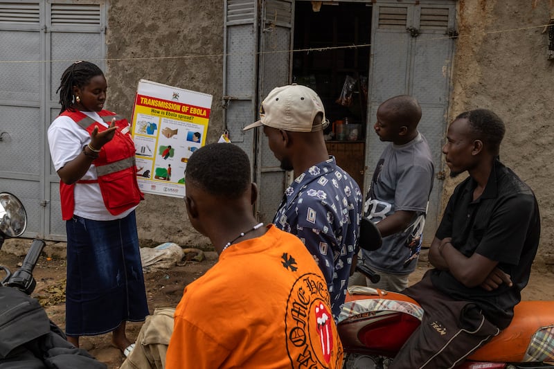 A member of the Red Cross Uganda team carries out an Ebola sensitisation campaign in Bundibugyo. Photograph: Stuart Tibaweswa/The New York Times