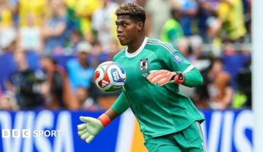 Zion Suzuki controls the ball with his chest while playing for Japan at the World Cup