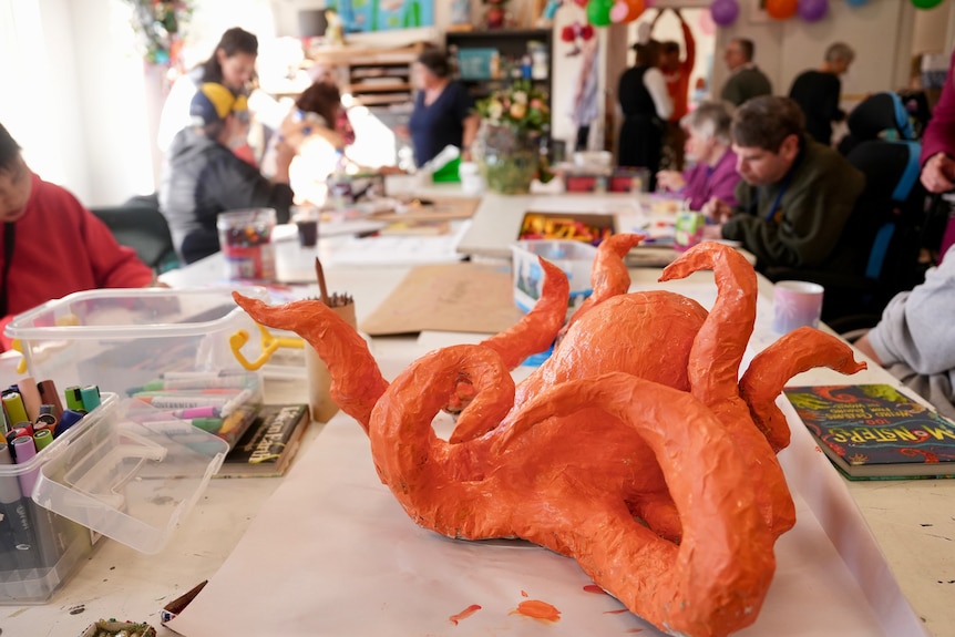 An orange octopus artwork on the table.