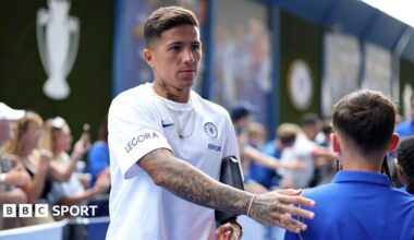 Enzo Fernandez taps a child fan on the back when entering the stadium to play for Chelsea