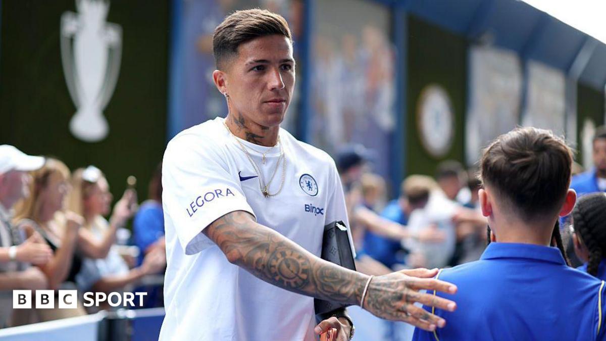 Enzo Fernandez taps a child fan on the back when entering the stadium to play for Chelsea