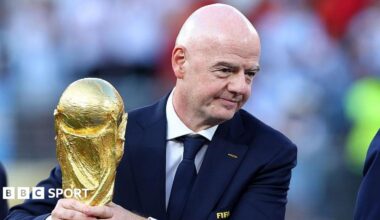 Gianni Infantino holds the World Cup trophy