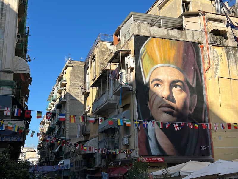 International flags fly in front of a mural of Naples' patron saint, San Gennaro. Photograph: Naomi O'Leary