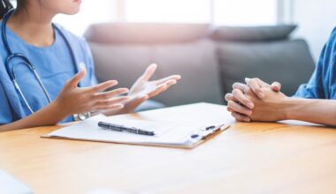Physician discussing sexual dysfunction in chronic hepatitis B during a confidential patient consultation.