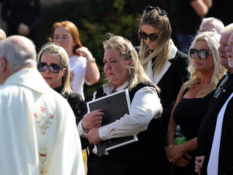 Friends and family look on as the remains are taken from church after the funeral Mass of Jeremy "Bobbles" O'Brien on Monday. Photograph: Collins 