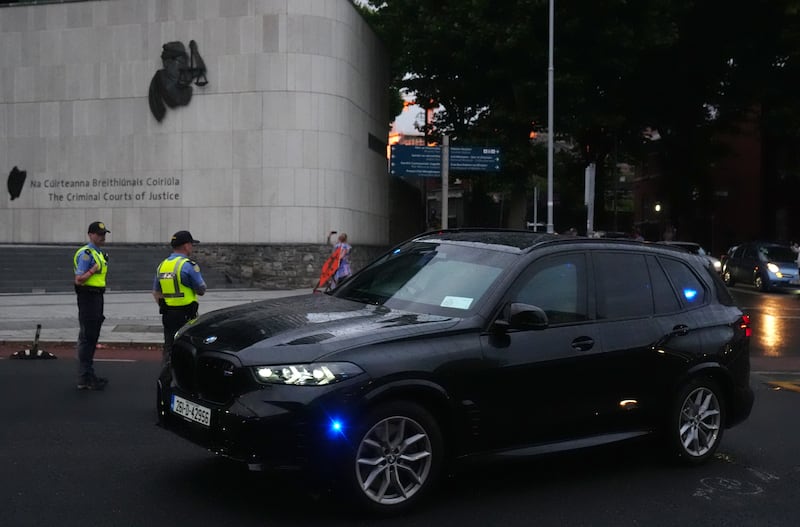 Garda vehicles leaving the Criminal Courts of Justice in Dublin, where Daniel Kinahan has been remanded in custody charged with directing an organised crime group, after being extradited from Dubai. Photograph: Brian Lawless/PA Wire