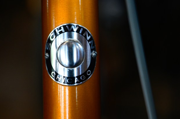 The badge on the head tube of a 1965 Schwinn Varsity in Radiant Coppertone color 10-speed bicycle is seen at University Bicycles in Boulder on July 23. The bicycle makes an appearance in the documentary film "No Hands: The Wild Ride of the Schwinn Bicycle Company." (Matthew Jonas/Staff Photographer)