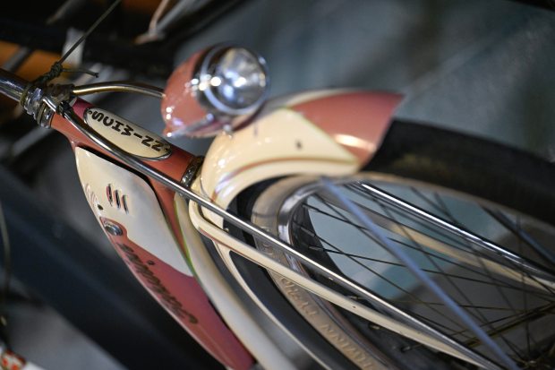 The badge on the head tube of a 1951 Schwinn Starlet in Summer Cloud White color with a step through frame that was marketed to women and girls is seen in the "Bike Museum" at University Bicycles in Boulder on Thursday, July 23, 2026. The bicycle makes an appearance in the documentary film "No Hands: The Wild Ride of the Schwinn Bicycle Company." (Matthew Jonas/Staff Photographer)