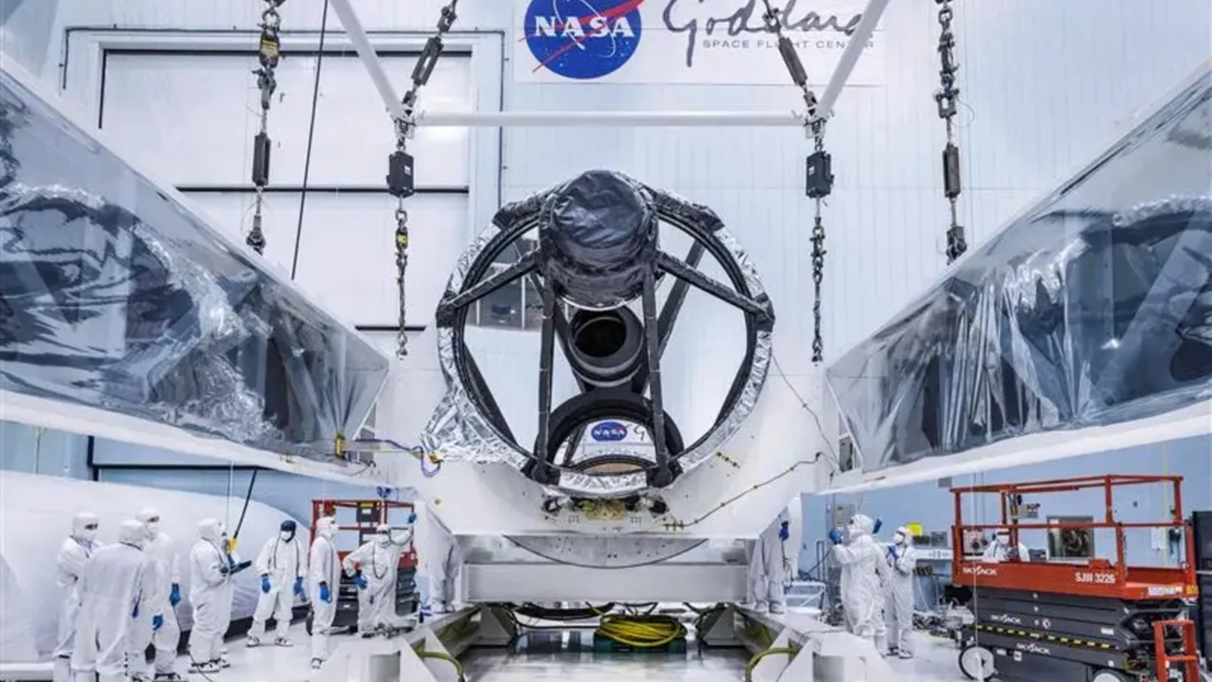 Photo of Roman's telescope being placed into the telescope in a NASA clean room