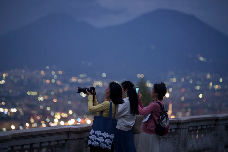 Visitors to Naples view the historic districts of the city below from the terrace opposite Castel Sant'Elmo. Photograph: Richard Baker/In Pictures via Getty