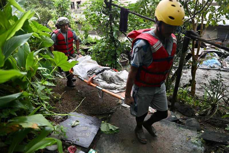Rescue personnel carry the body of a victim who died after flash floods near Devighat, Bidur Municipality, in Nepal's Nuwakot district. Photograph: Ishara S. KODIKARA/AFP via Getty Images