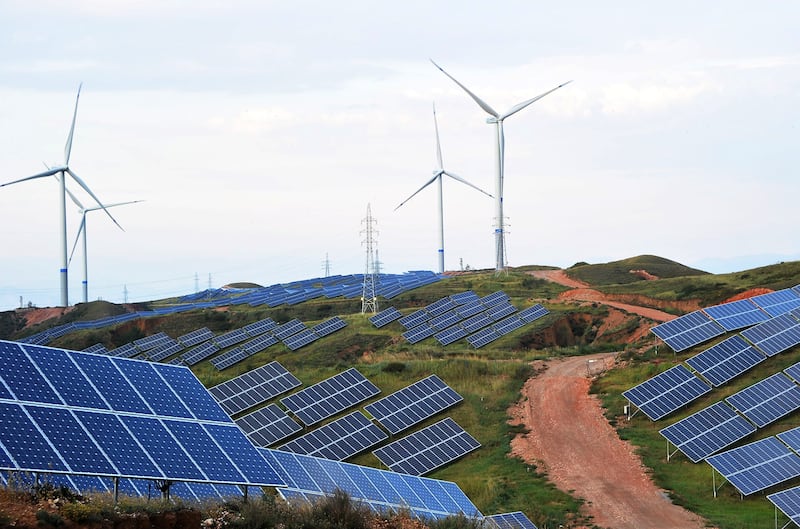 Solar panels and wind turbines are pictured on a barren mountain at Shenjing Village in Zhangjiakou, Hebei province, China. Photograph: VCG via Getty Images