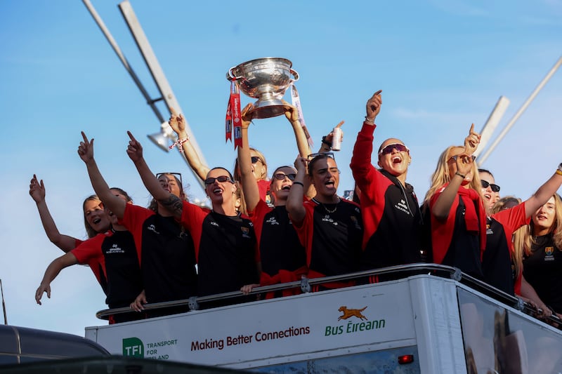 The Cork camogie team celebrate with the O’Duffy Cup during their homecoming in the city centre on Monday night. Photograph: Tom Maher/Inpho