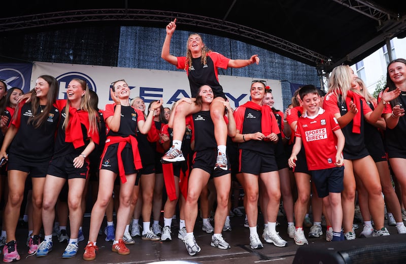 Cork's Laura Hayes and Saoirse McCarthy (centre) lead the celebrations during the homecoming. Photograph: Tom Maher/Inpho