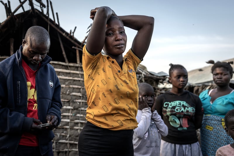 Chantal Imani cries outside the hut of her sister, Espérance Raciu Ucwimungu (40), who had died of Ebola-like symptoms at the Tsere camp in Rwampara on June 26th, 2026. Photograph: Finbarr O'Reilly/The New York Times
                      