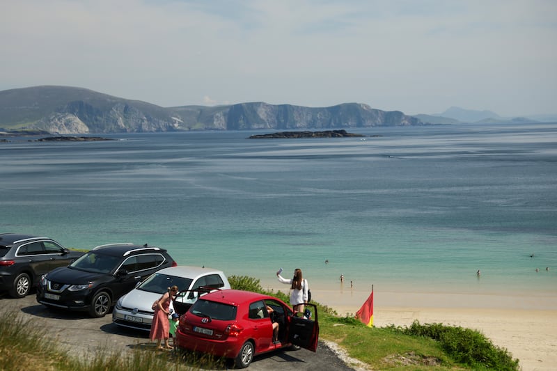 People take in the view of Keem Bay in Achill, Co, Mayo. Photograph: Enda O'Dowd