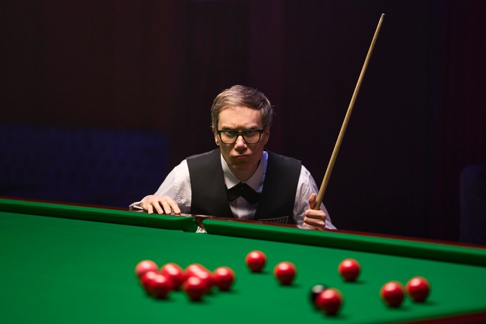 Ludwig_S2_EP4_261125_0245 Stephen Merchant as snooker champion Danny Sloane in Ludwig season 2; wearing a black and white player's suit, and assessing a snooker game in progress