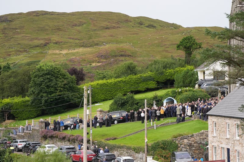 The hearses carrying the coffins of James and Noreen McHugh leave St Cartha's Church after the funeral. Photograph: Niall Carson/PA Wire