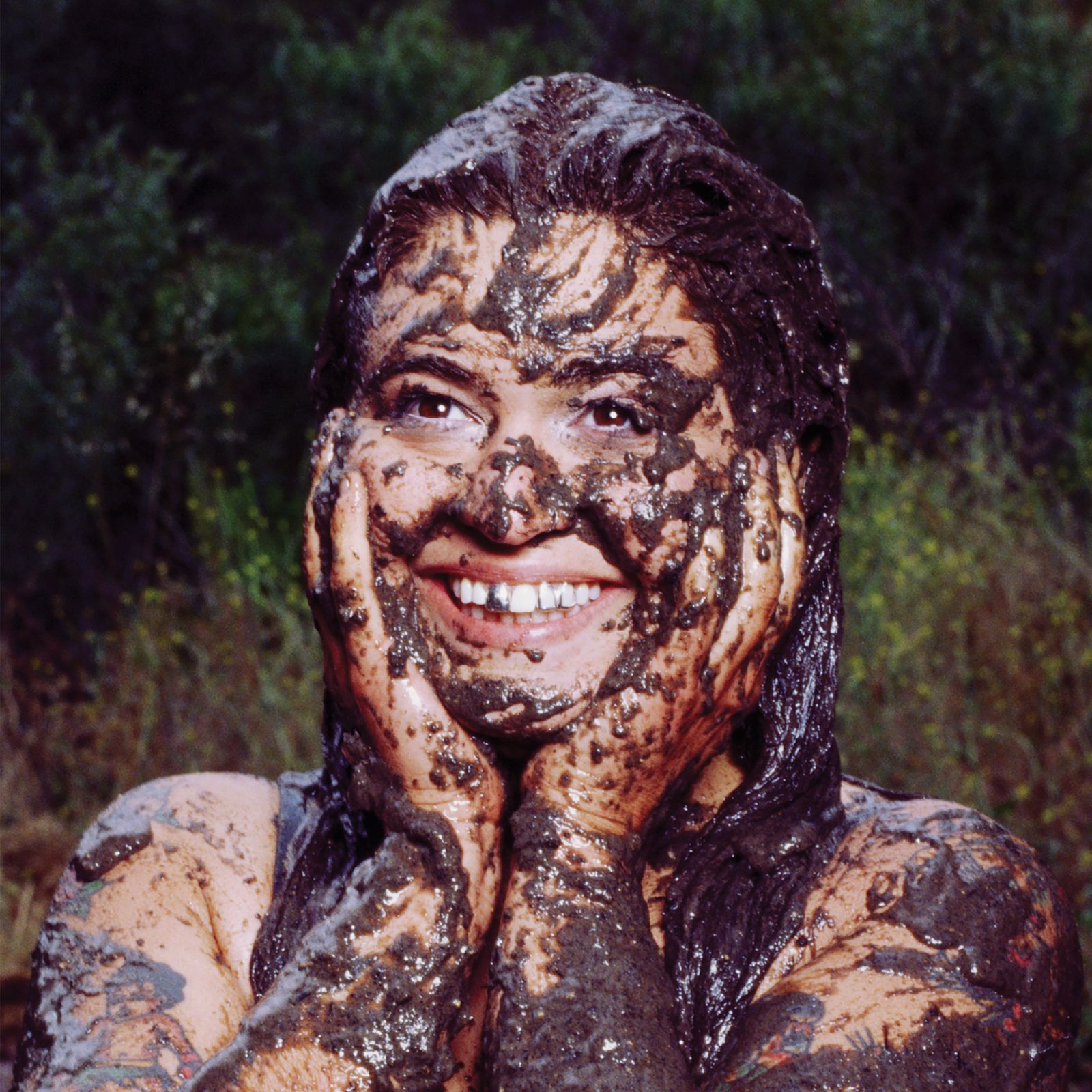 Image may contain Face Head Person Photography Portrait Mud Adult Body Part Mouth Teeth Happy Smile and Clothing