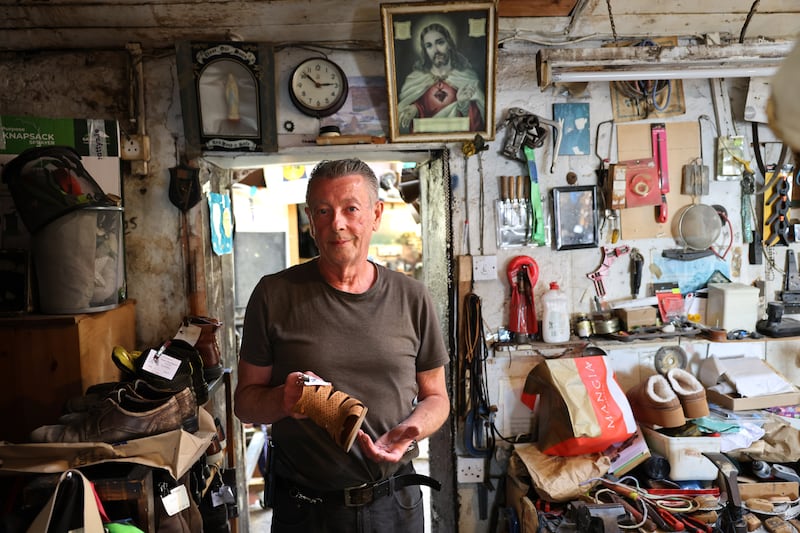 Neill Ryan in his cobbler's shop, Ryan’s Shoe Repairs, beside the North Gate in Athenry. Photograph: Dara Mac Dónaill