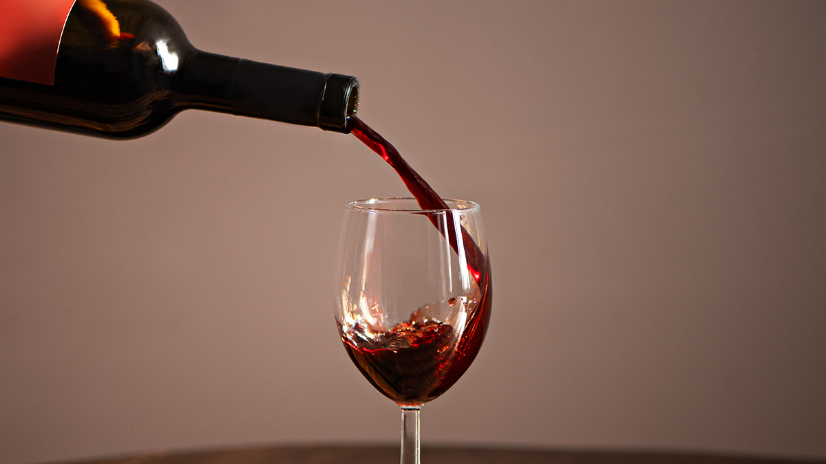 Red wine pouring into a glass