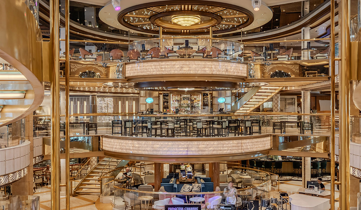 rincess Piazza atrium, the vibrant social hub and architectural centerpiece found across Princess Cruises' Royal-class ships. Pic: Supplied