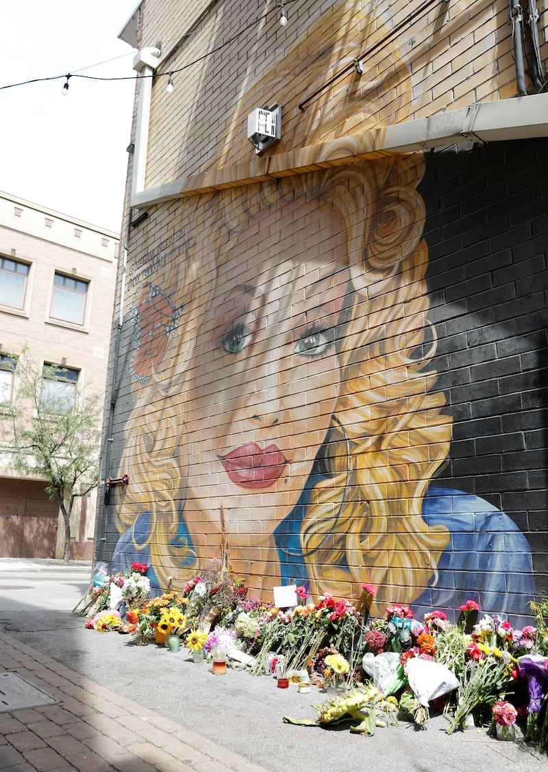 Flowers and letters are placed at the Dolly Parton mural by artist Megan Lingerfelt in Strong Alley on August 26, 2026 in Knoxville, Tennessee. Photograph: Jason Kempin/Getty Images