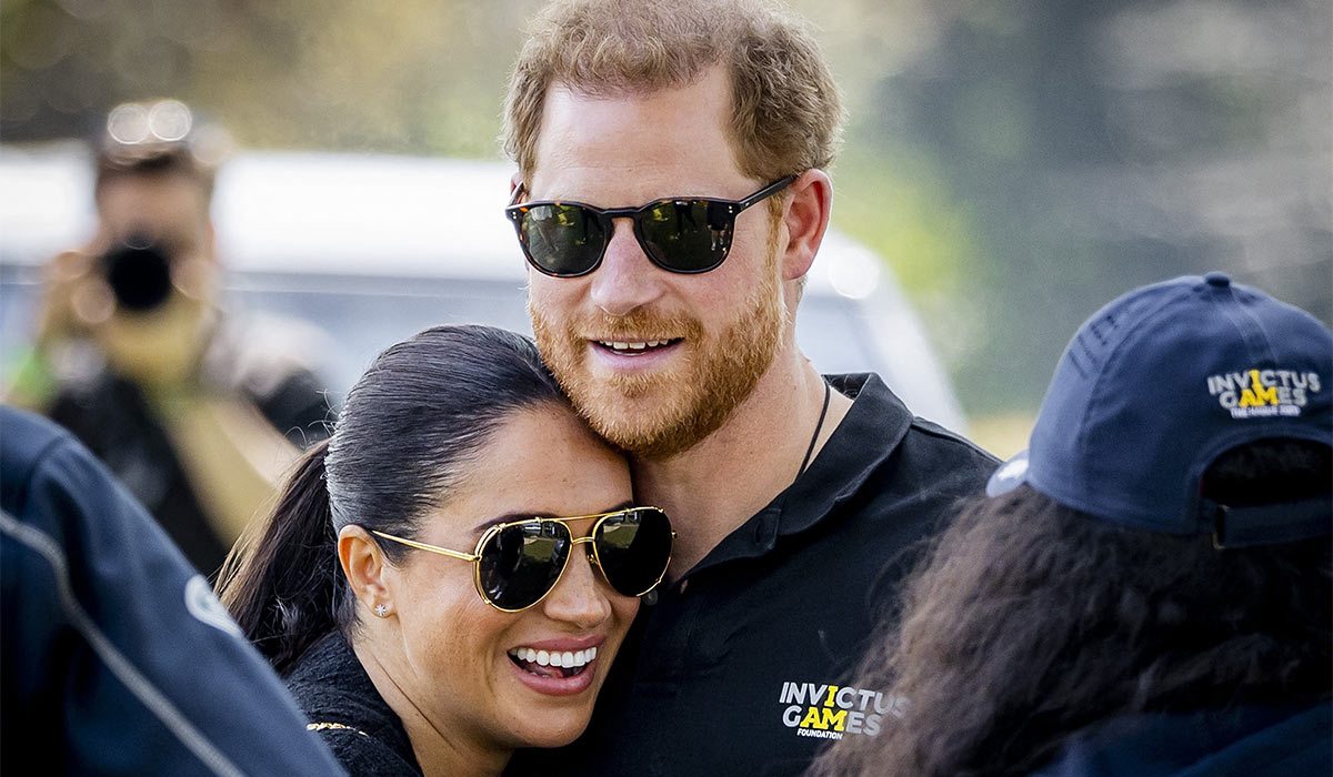 Britain's Duke and Duchess of Sussex, Prince Harry (R) and his wife, Meghan Markle embrace at The Invictus Games in The Hague. Pic: Getty Images