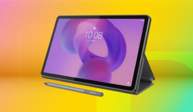 Black Lenovo Idea Tab and stylus against yellow and mint green CNET background.