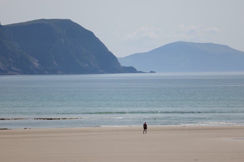 A person walks along Keel beach in Achill, Co Mayo. Photograph: Enda O'Dowd