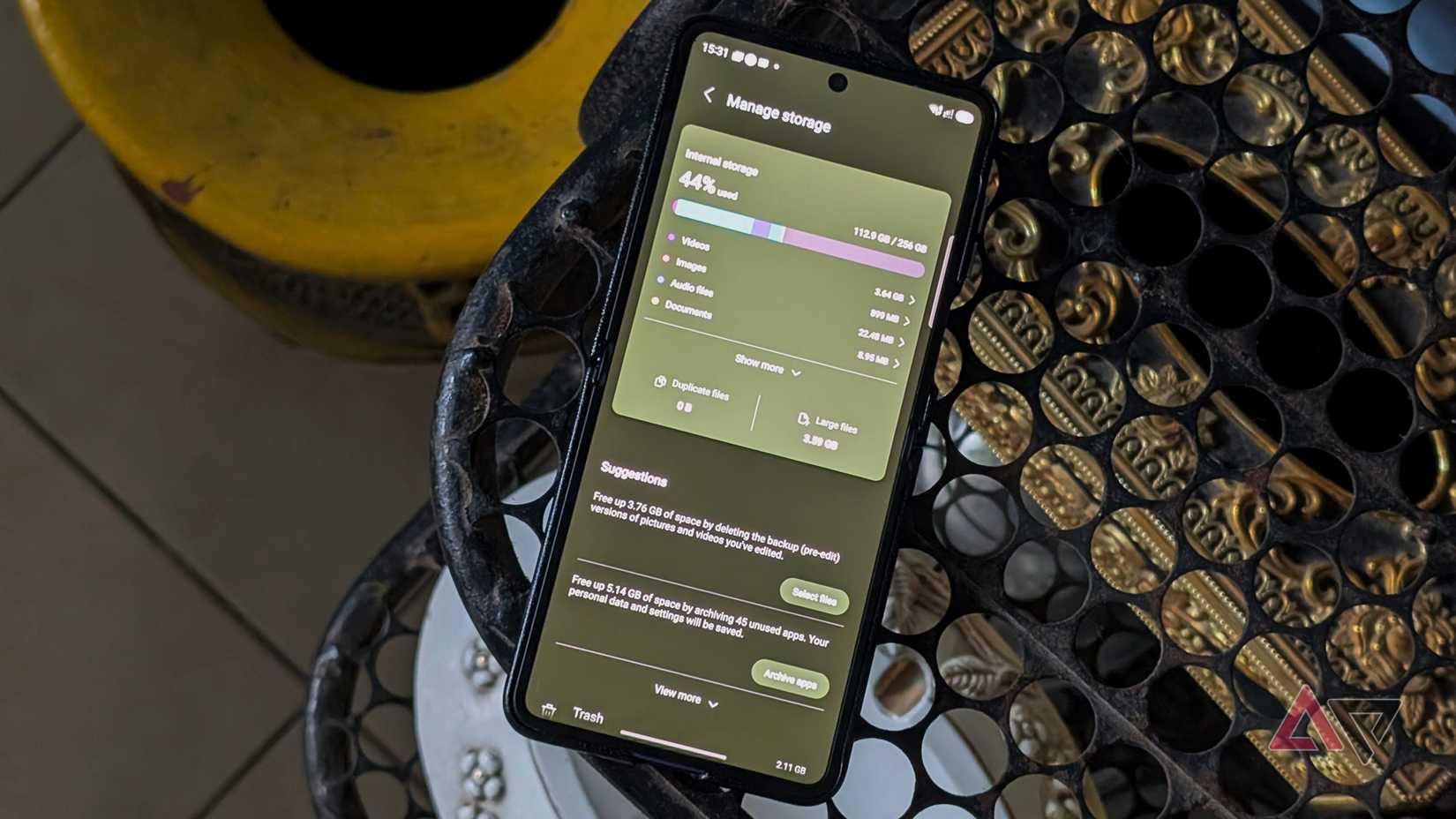 Samsung Galaxy Z Flip 7 smartphone on a perforated rack showing the manage storage screen