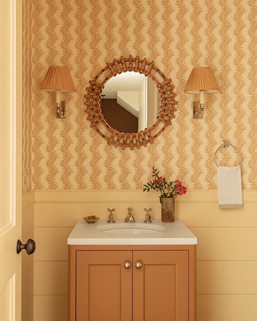 powder room with butter yellow walls and wallapper