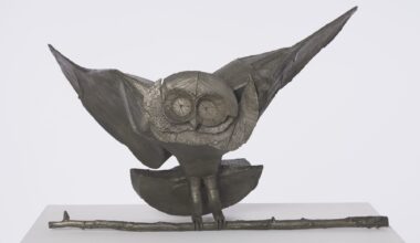 a bronze sculpture of a slightly cartoonish owl