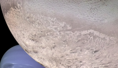 Voyager 2 passed Neptune's moon Triton in 1989 and photographed it erupting, a discovery scientists called the flyby's biggest surprise — dark plumes rising nearly eight kilometres and then drifting 150 kilometres downwind, on the coldest surface known