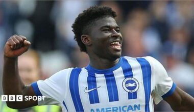 Carlos Baleba of Brighton & Hove Albion celebrates in front of the supporters