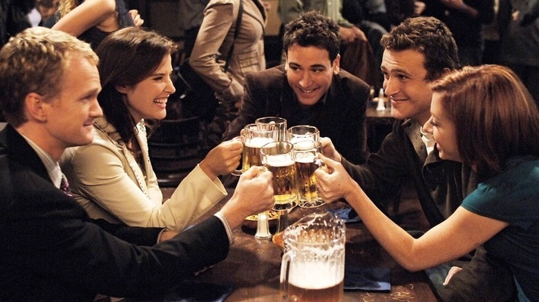 Barney, Robin, Ted, Marshall, and Lily cheers beer glasses in 