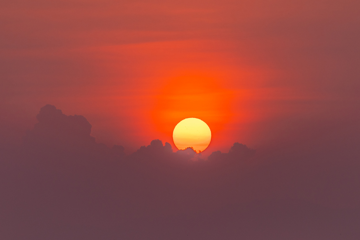 Dramatic sunset sky view with clouds and sunbeam. Hoi An - Vietnam.