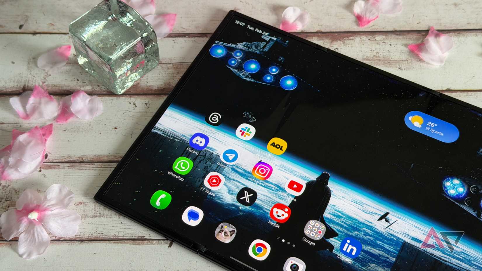 Samsung Galaxy Z TriFold unfolded and surrounded by petals