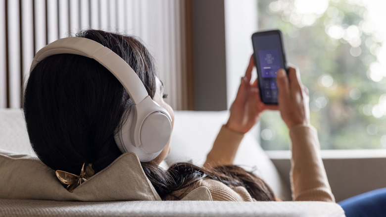 A woman listening to music via Bluetooth headphones.