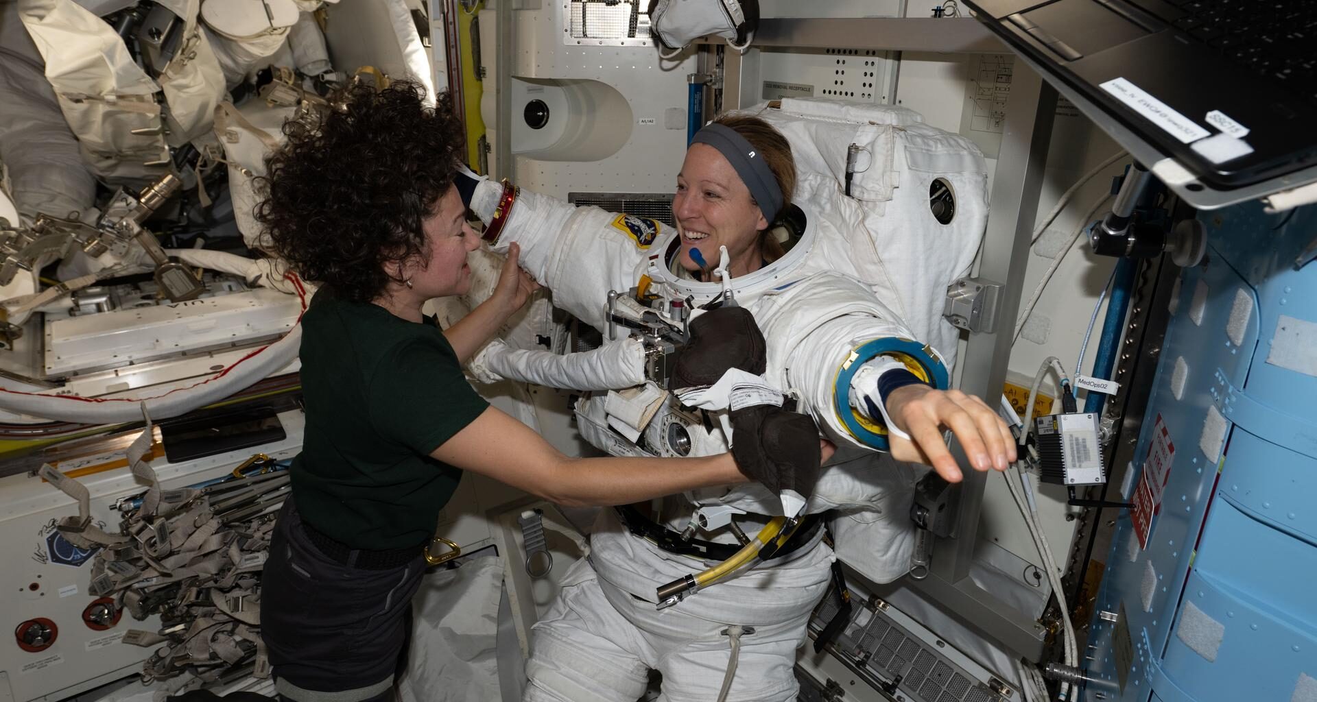 Expedition 74 flight engineers Sophie Adenot of ESA (European Space Agency) and Jessica Meir of NASA work together inside the International Space Station’s Quest airlock. Adenot is wearing a spacesuit in a powered and pressurized configuration to test its mobility, comfort, and optimal fit. Meir also assisted Adenot in conducting suit leak and pressure checks while verifying the suit’s communications hardware and life‑support systems.