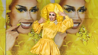 Drag Queen Tequila, wearing a puffy yellow dress and a big bright yellow whig